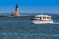 Boat Passes by Halfway Rock Lighthouse in Maine